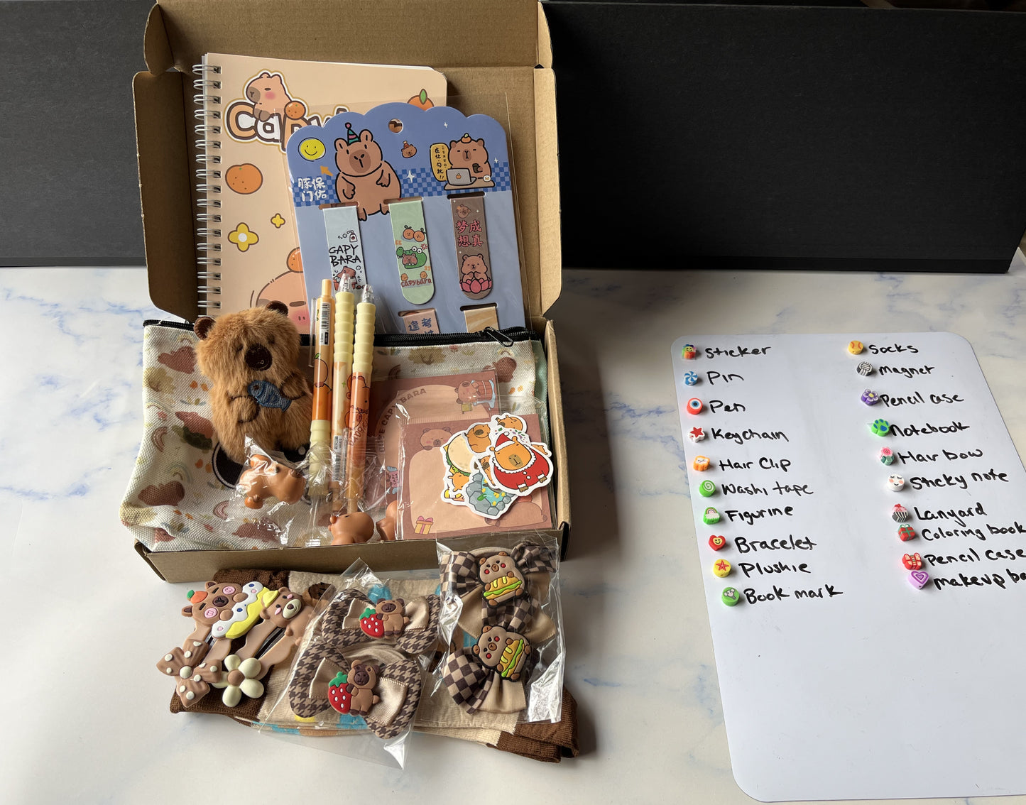 a capy mystery box next to a whiteboard that declares the prizes.
